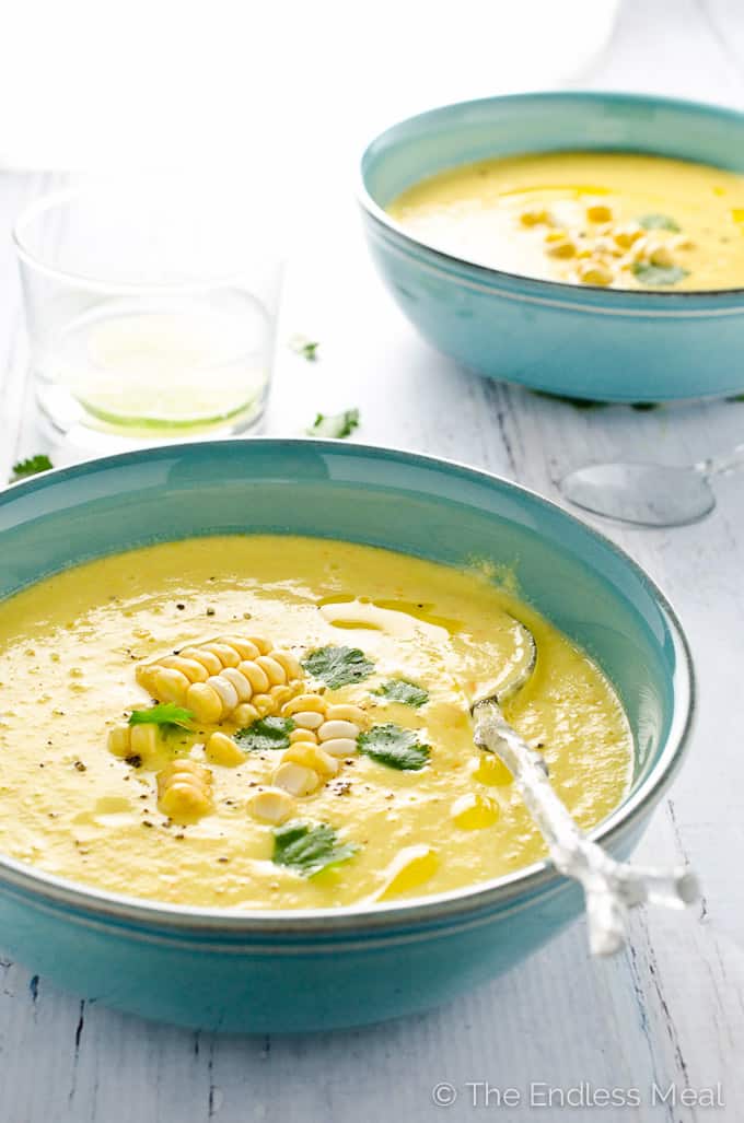 45 degree angle of vegan sweet corn gazpacho in a blue bowl