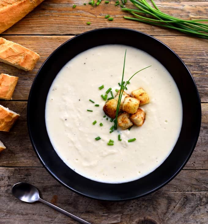 Overhead of chilled vegan vichyssoise potato leek soup 