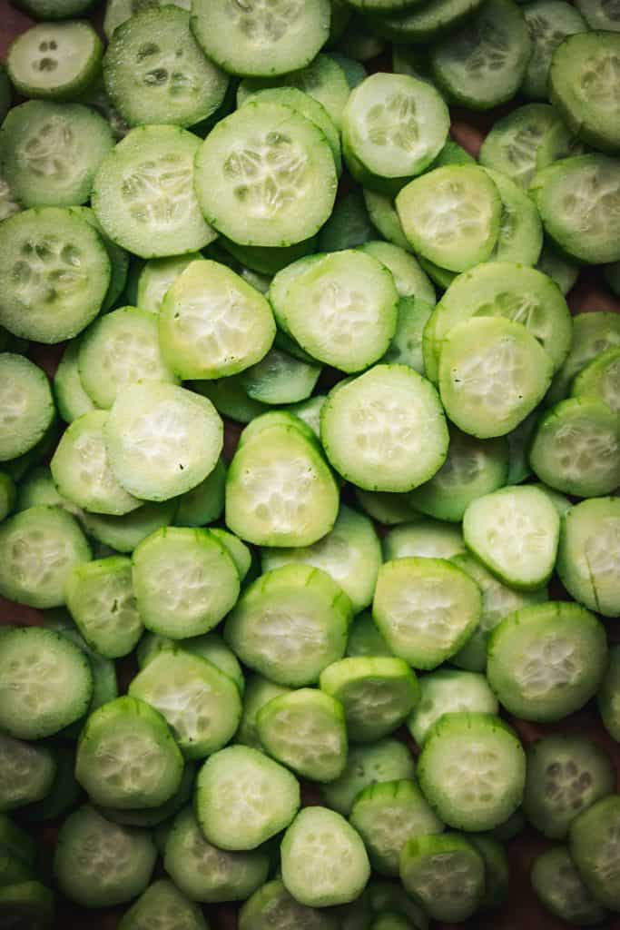 overhead of sliced, peeled cucumbers