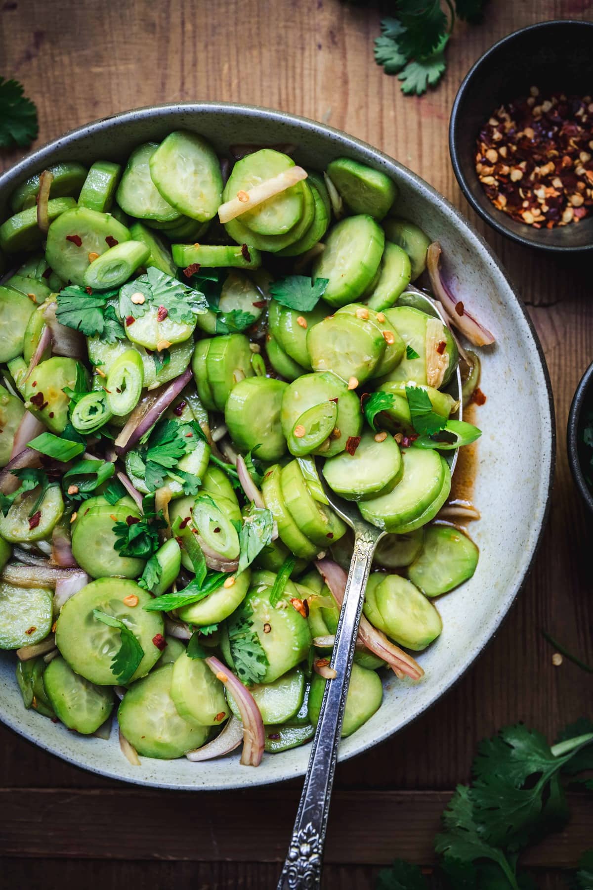 overhead of asian cucumber salad with ginger dressing in a bowl