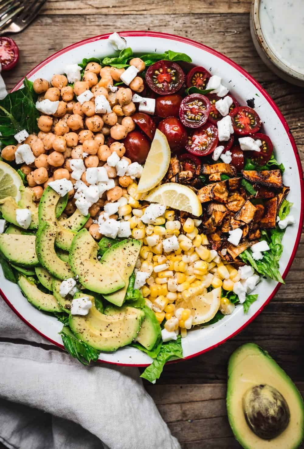 overhead of colorful vegetables in a vegan cobb salad with eggplant bacon and homemade vegan ranch dressing