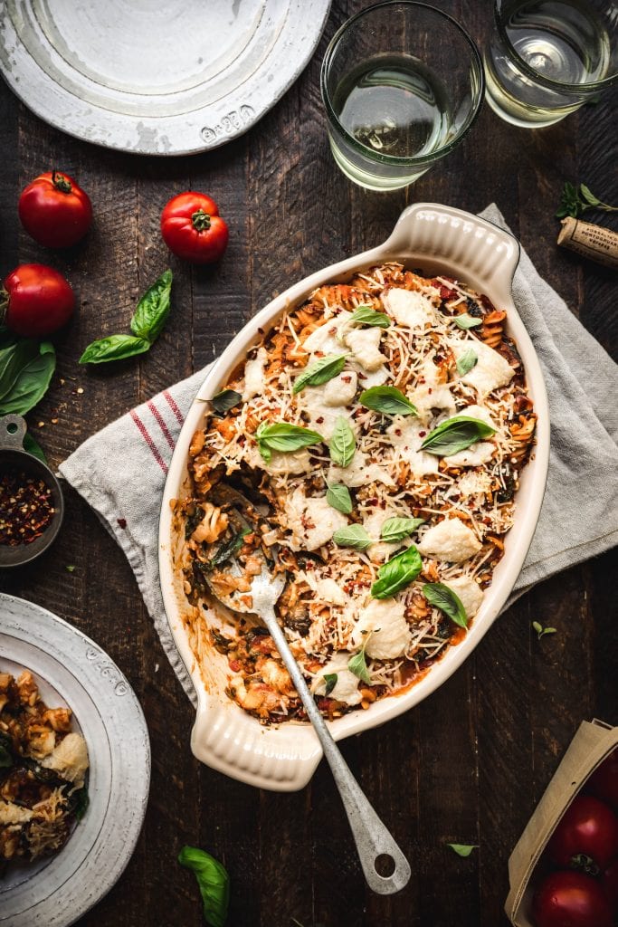 Overhead view of healthy vegan pasta bake on a rustic wood surface