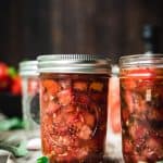 side view of tomato bruschetta in a jar
