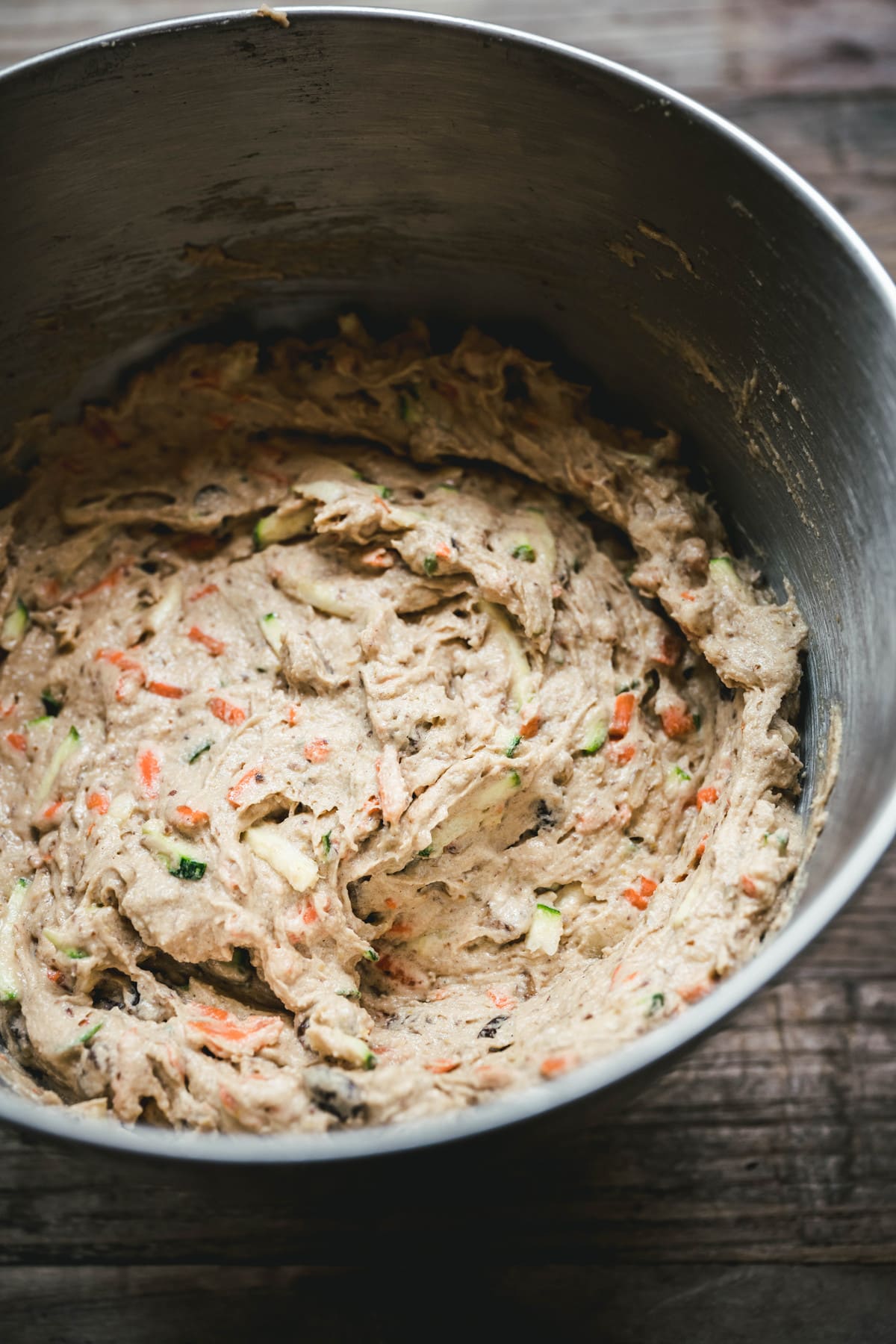 overhead of a mixing bowl with the batter for vegan gluten free carrot zucchini muffins