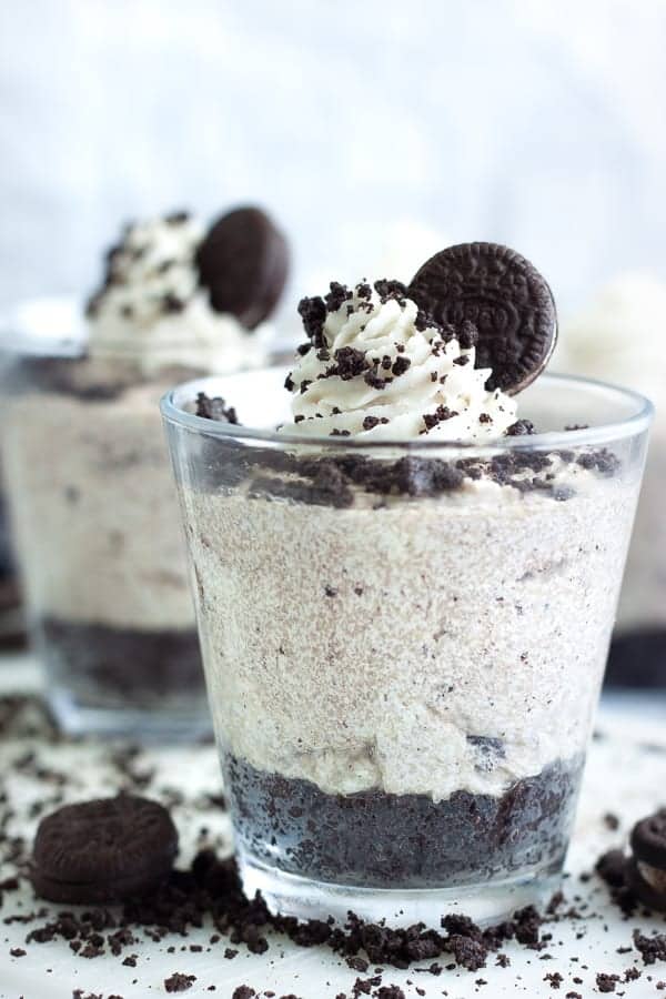 side view of vegan oreo cheesecake in a glass