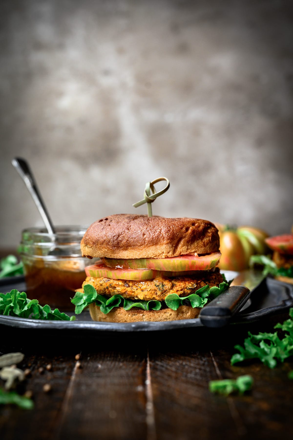 side view of indian-spiced veggie burger with mango chutney
