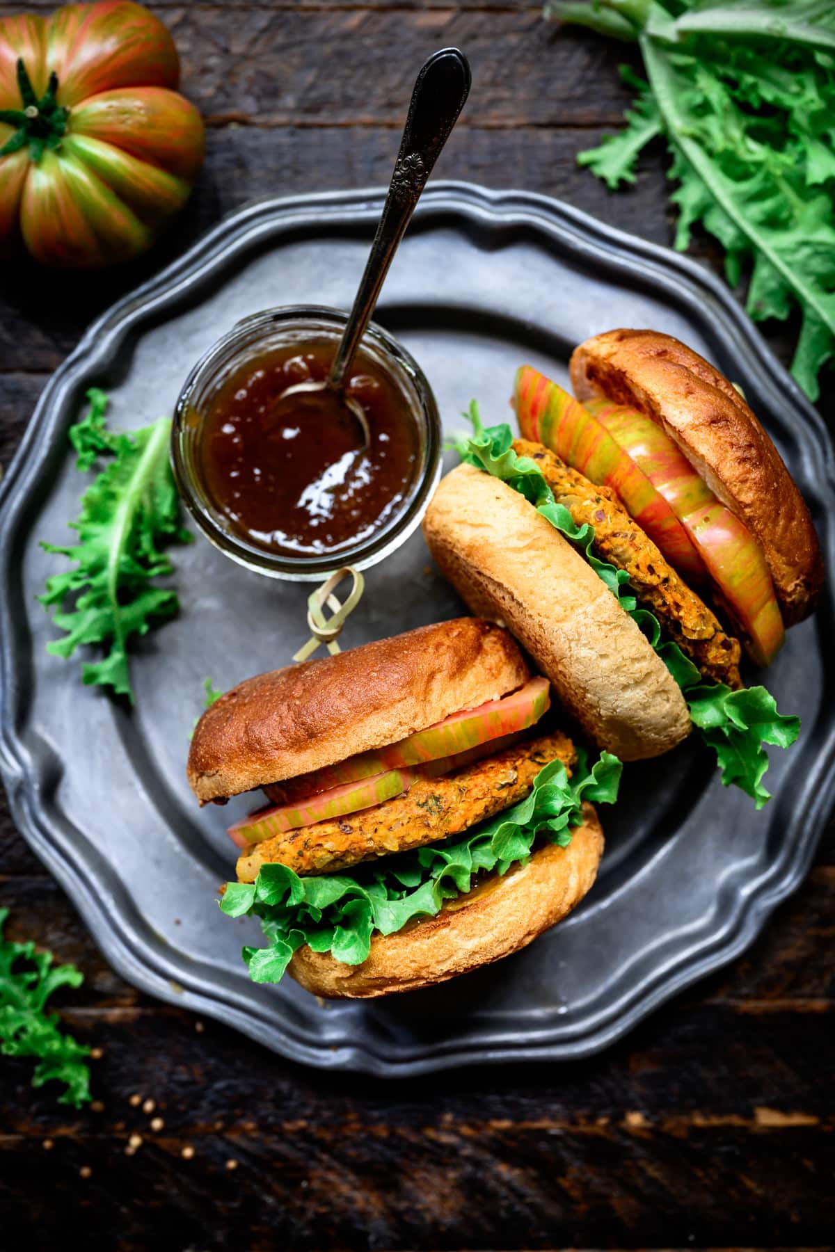 overhead view of two veggie burgers on a plate with mango chutney