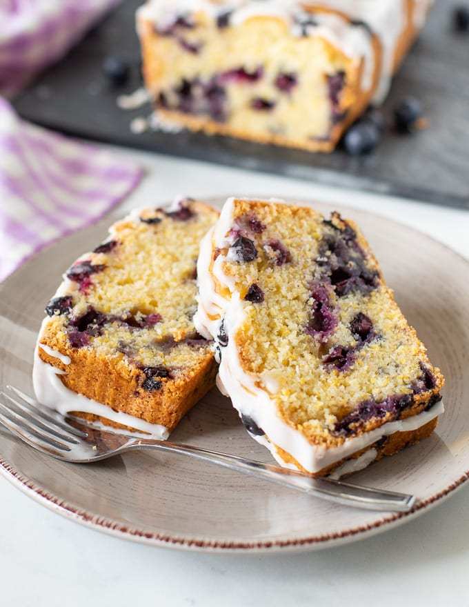 45 degree angle of two slices of lemon blueberry loaf from a virtual vegan