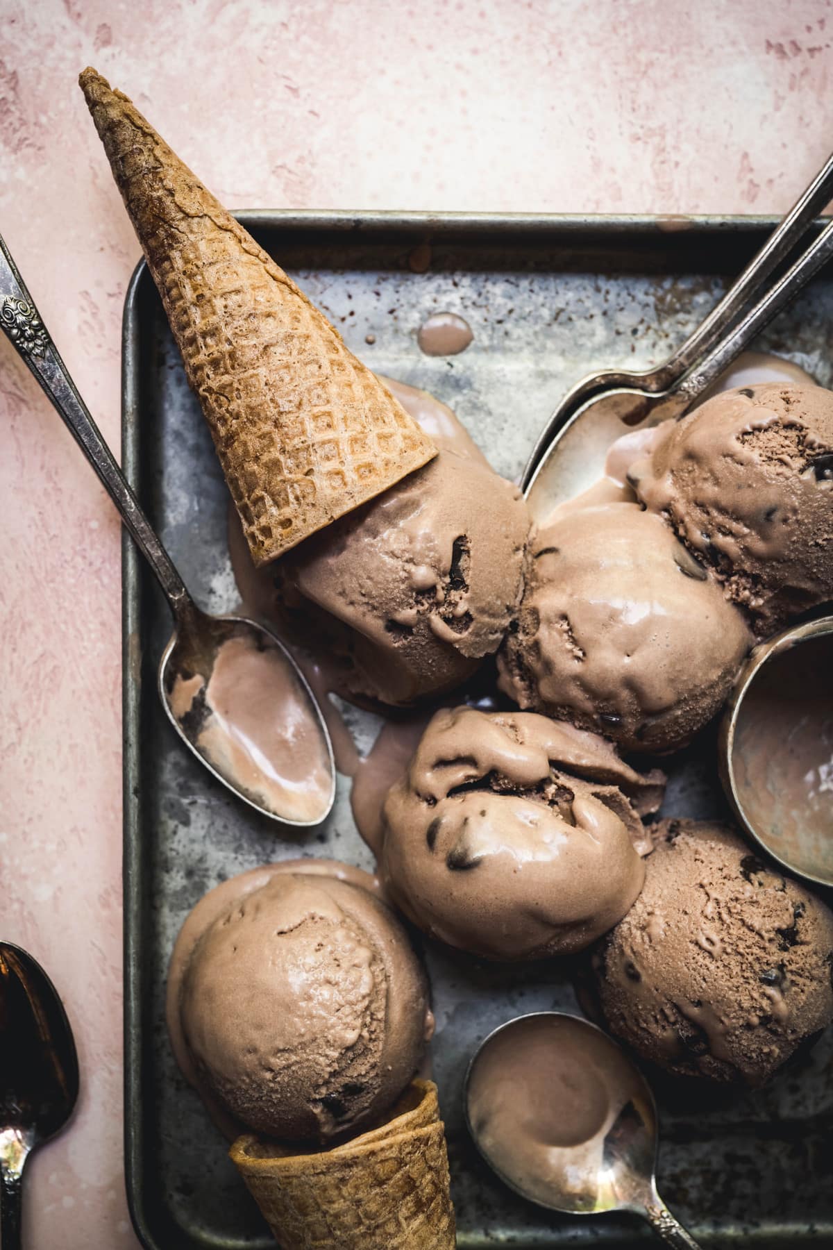 overhead of vegan mocha ice cream scoops on a try with ice cream cones