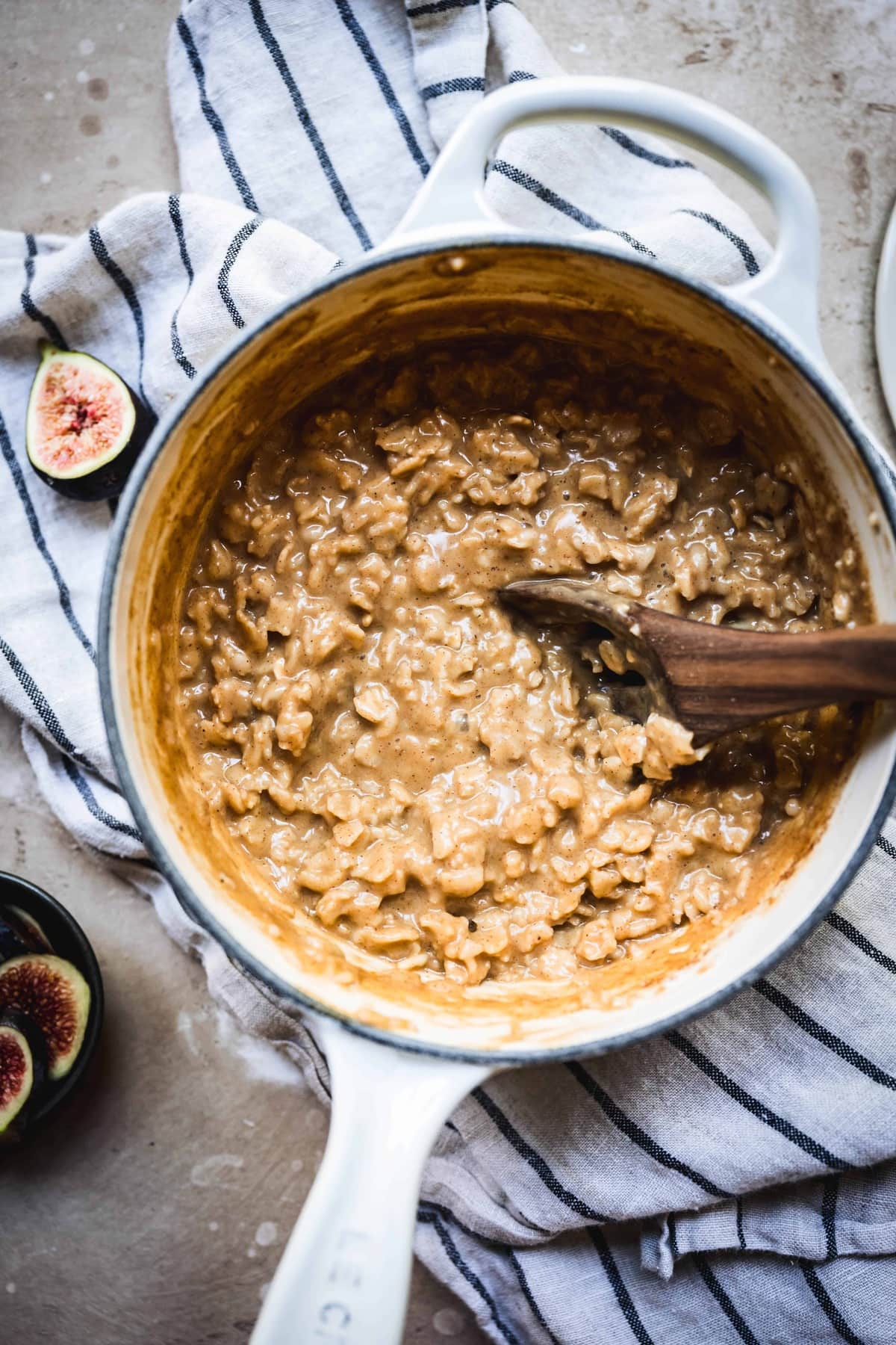 overhead view of pumpkin pie oatmeal in white saucepan