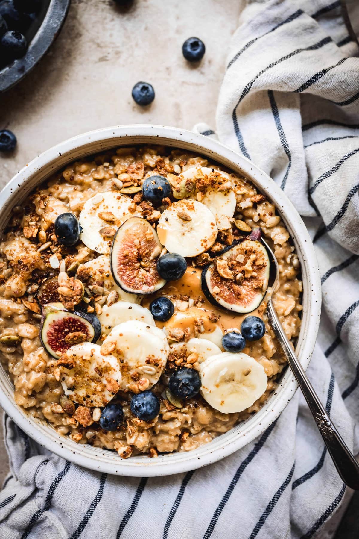 overhead view of pumpkin pie oatmeal recipe in a white bowl