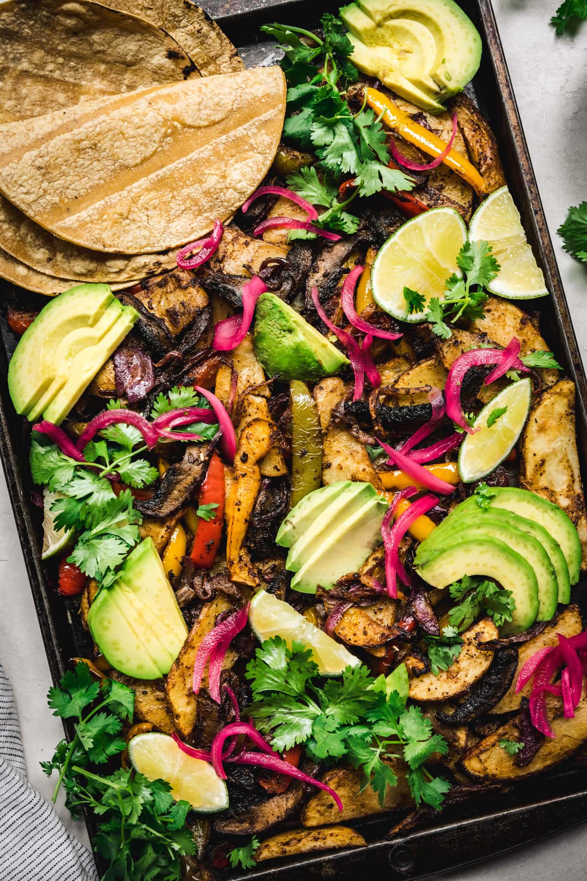 overhead of a full sheetpan of vegan portobello fajitas