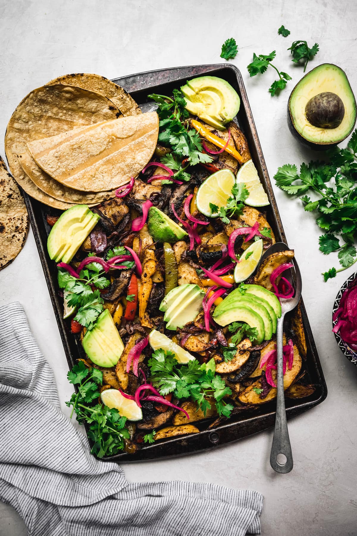 overhead of vegan portobello sheet pan fajitas with corn tortillas