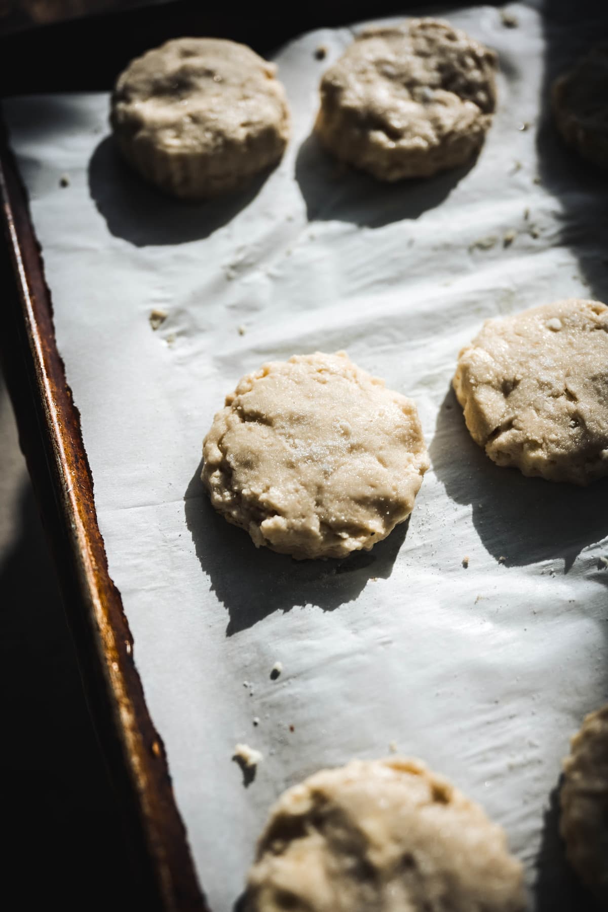 overhead of gluten free shortcakes on a parchment lined baking sheet