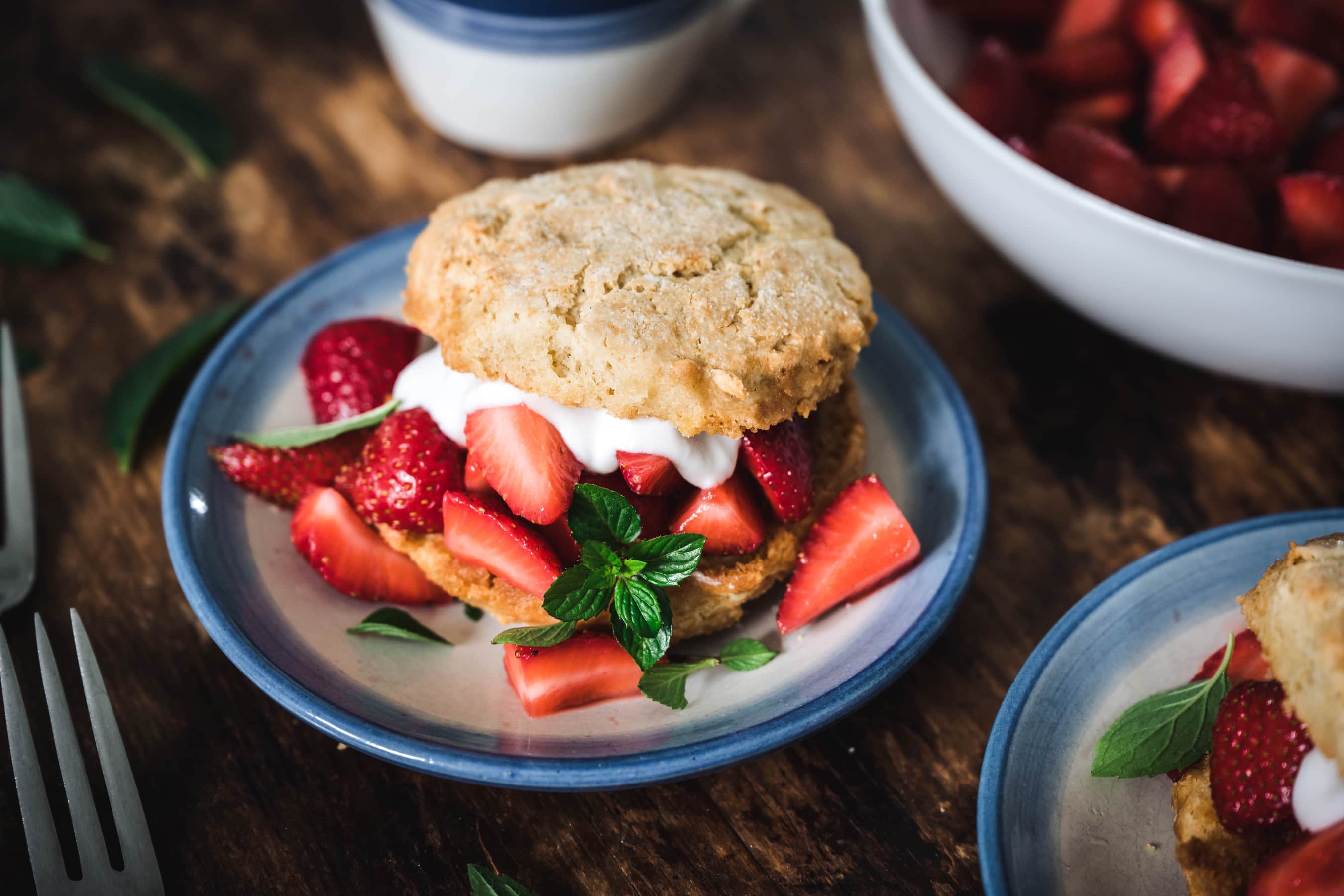 45 degree overhead of vegan strawberry shortcake on a white and blue plate