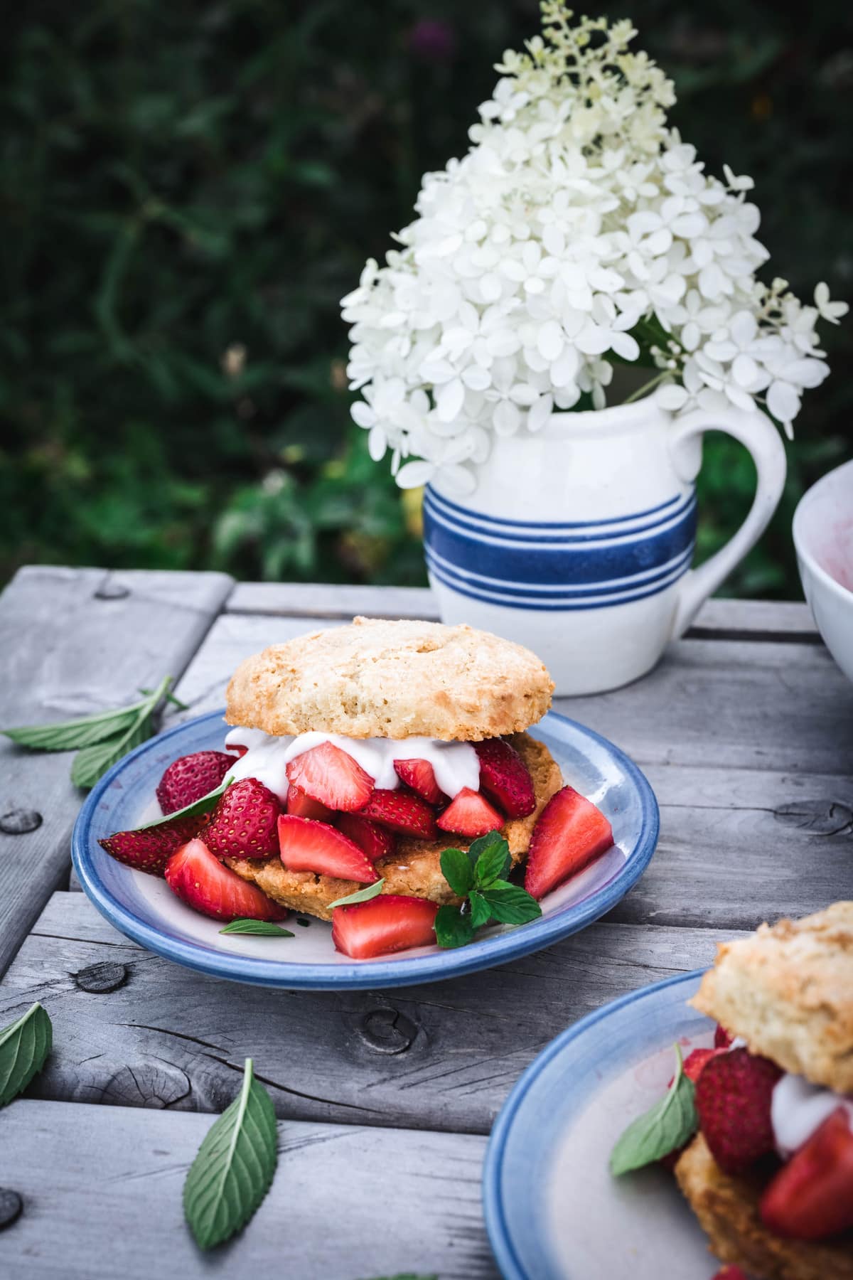 side view of vegan strawberry shortcakes on outdoor table
