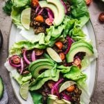 overhead of vegan lentil taco lettuce wraps on an oval platter