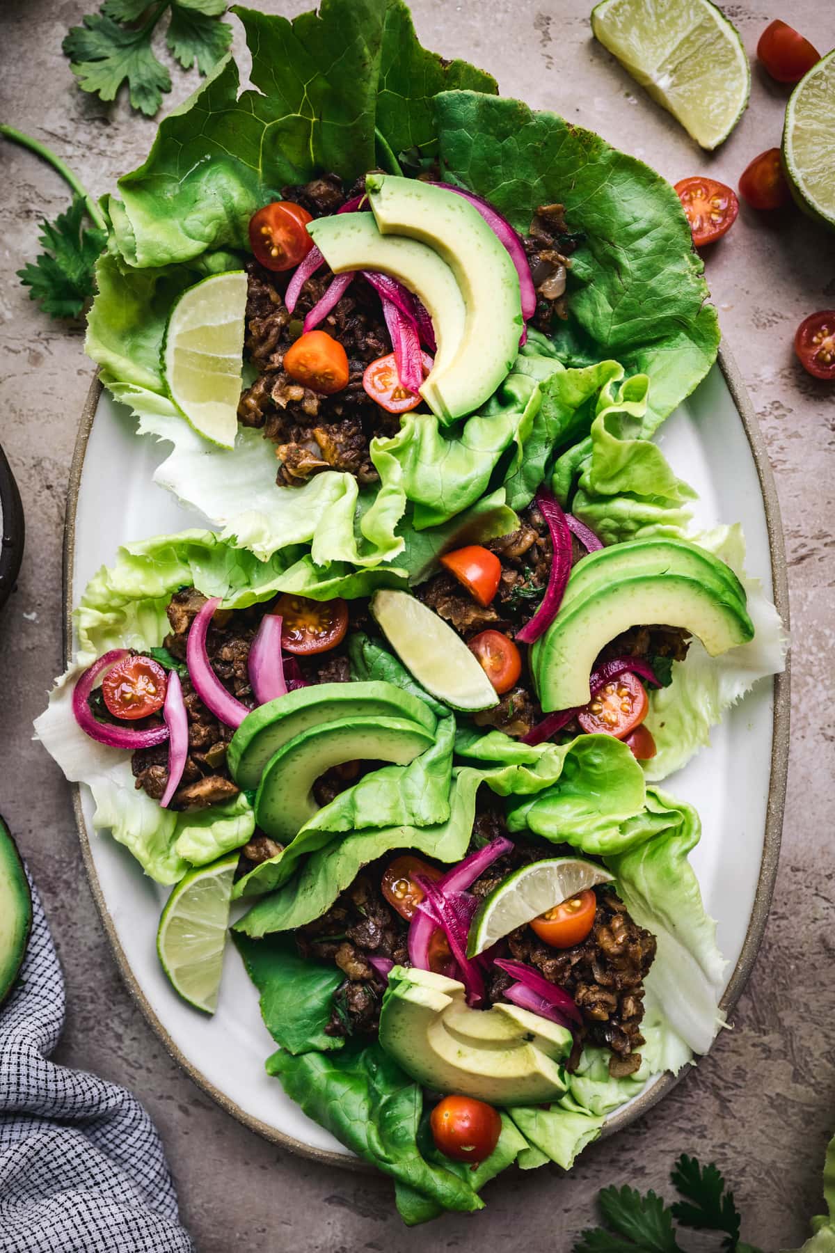 overhead of vegan lentil taco lettuce wraps on an oval platter