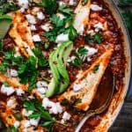 overhead of vegan shakshuka in a baking dish with a spoon