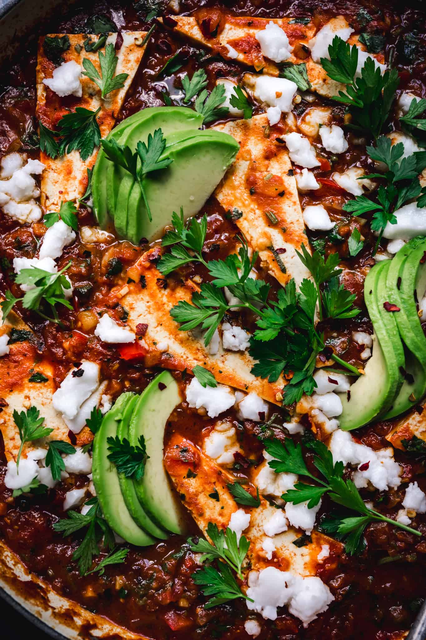 close-up of vegan shakshuka made with tofu and topped with avocado