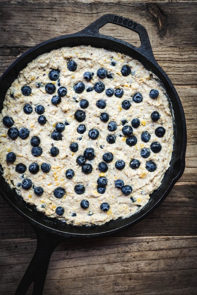 Overhead of blueberry cornbread in skillet before baking