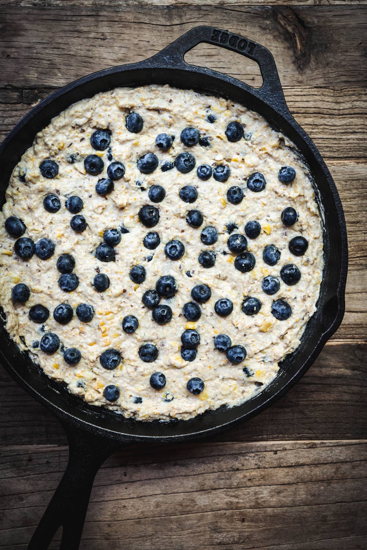 Overhead of blueberry cornbread in skillet before baking