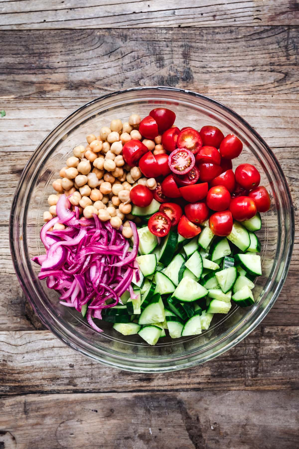 overhead of the four ingredients in chickpea cucumber salad before they're mixed together