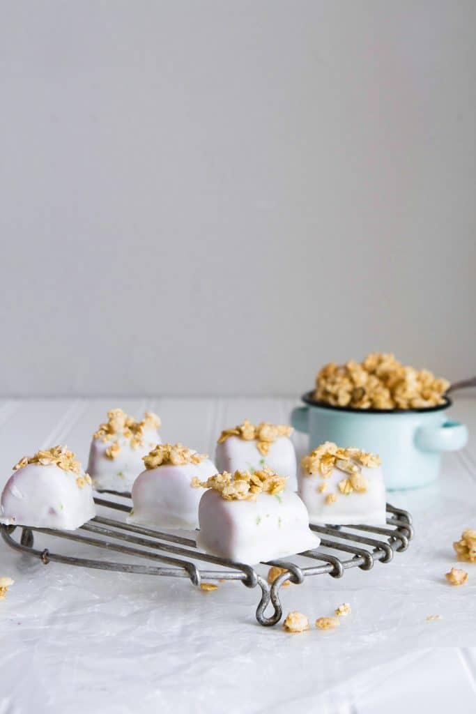 side view of tropical smoothie bites topped with granola on a wire rack