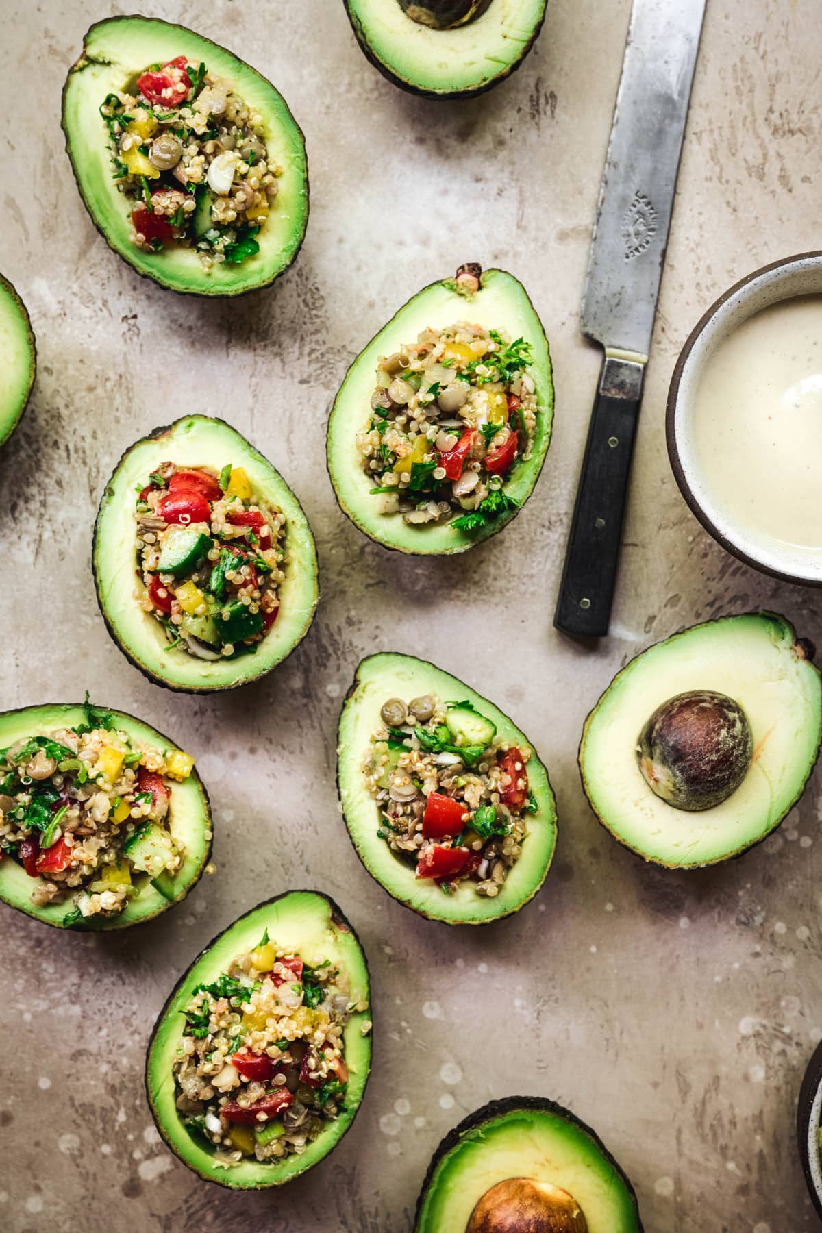 overhead view of vegan mediterranean stuffed avocados with sumac dressing