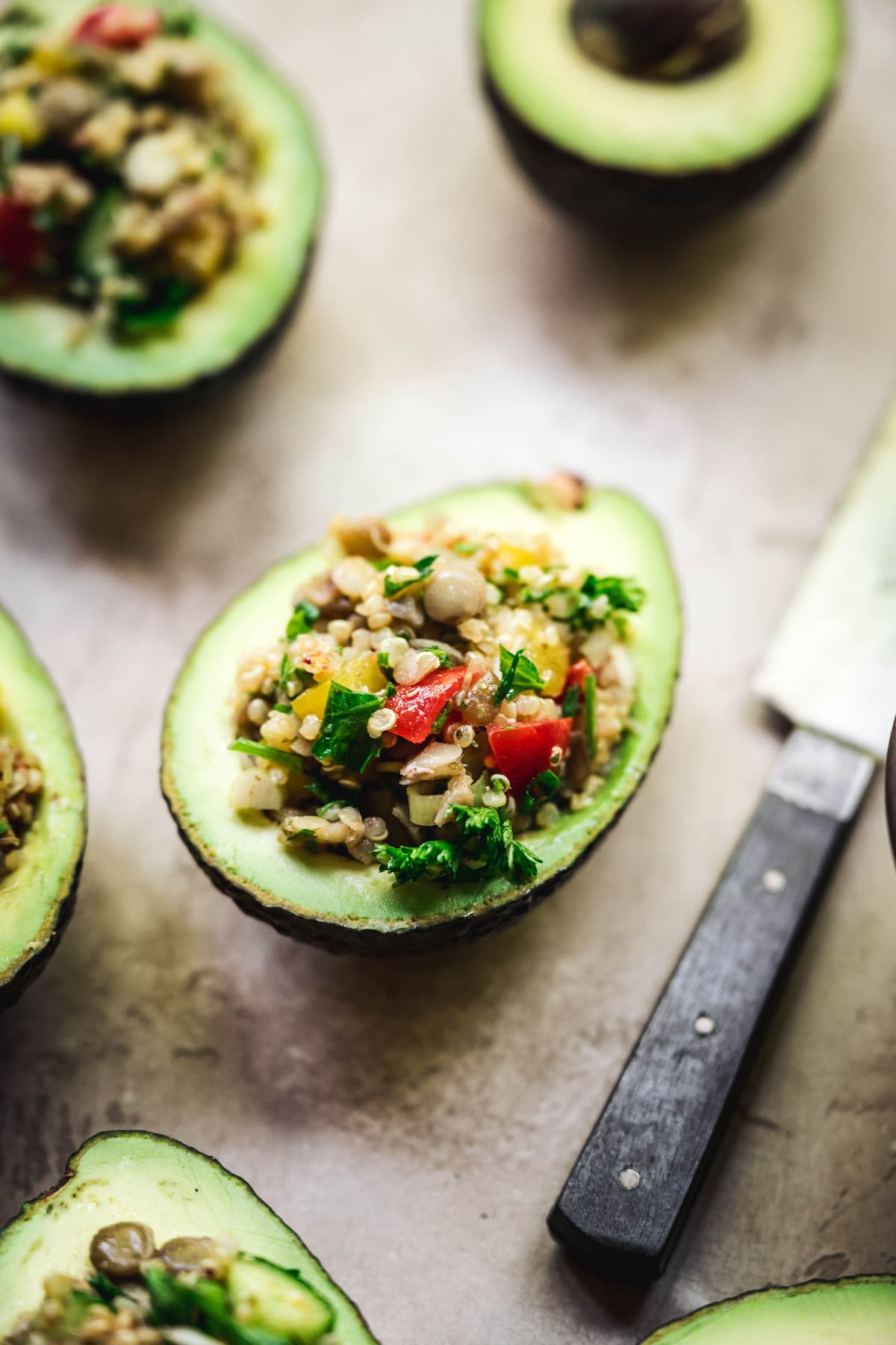 side view of vegan stuffed avocados with easy tahini dressing
