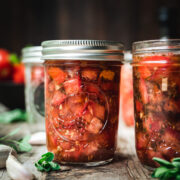 side view of tomato bruschetta in a jar