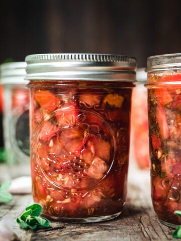 side view of tomato bruschetta in a jar