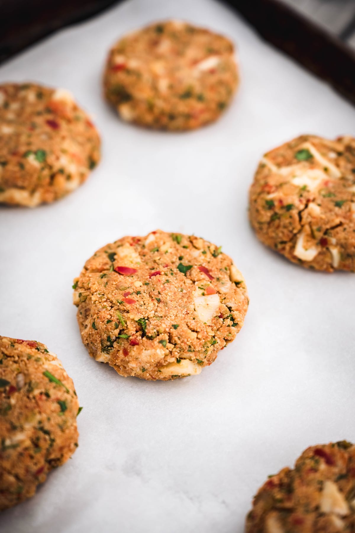 45 degree angle of vegan crab cakes before they're cooked on a baking sheet