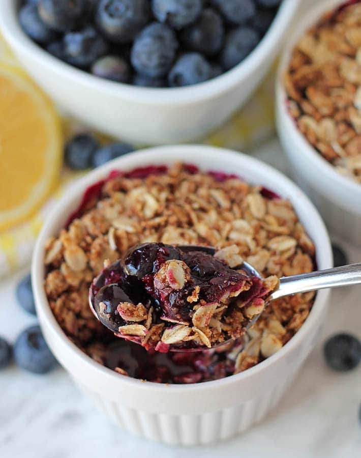 45 degree angle of vegan and gluten free blueberry crisp in a ramekin