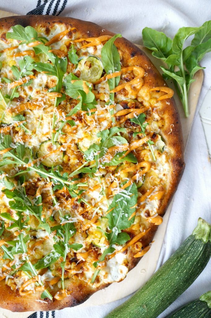 overhead of zucchini and corn pizza