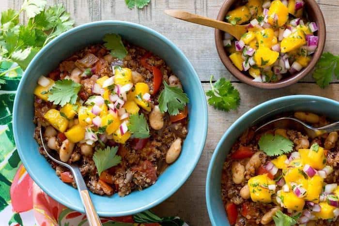 overhead of three bowls of vegan jamaican jerk chili with mango salsa