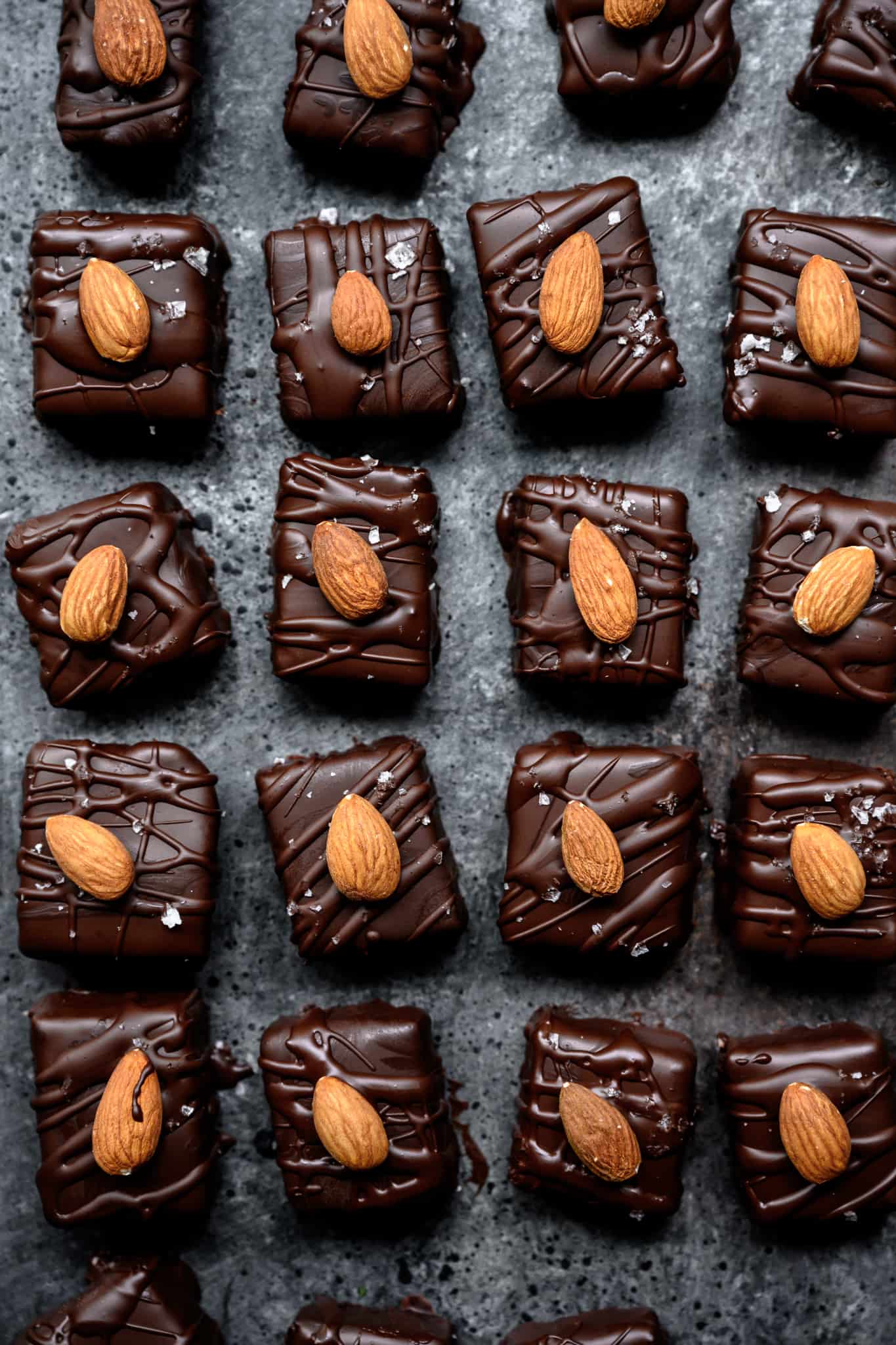 overhead view of mini almond joy bars on dark surface