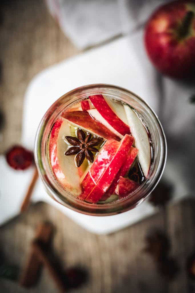 close up overhead of homemade apple and pear infused vodka