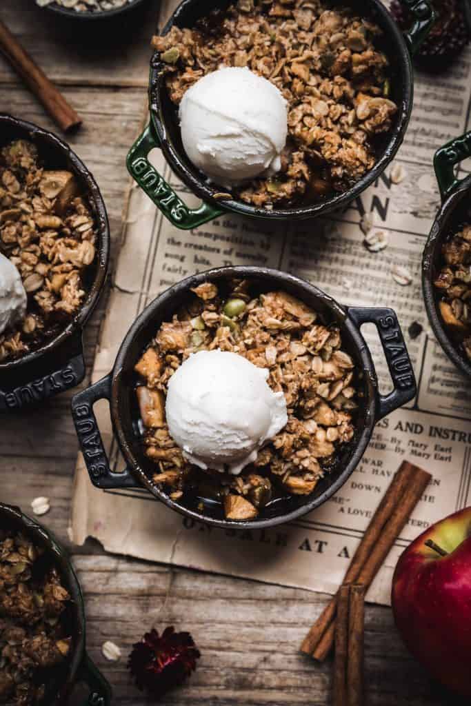 overhead of vegan apple crisp with vanilla ice cream on top