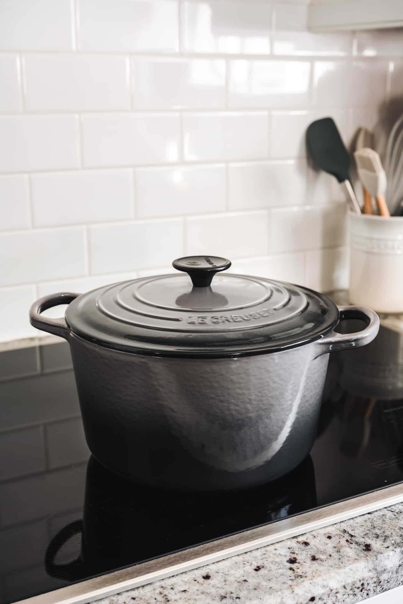 side view of gray Le Creuset dutch oven on induction stovetop 