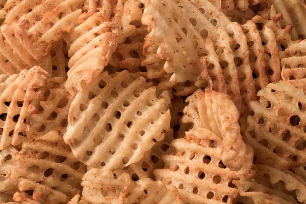 close up of seasoned waffle fries
