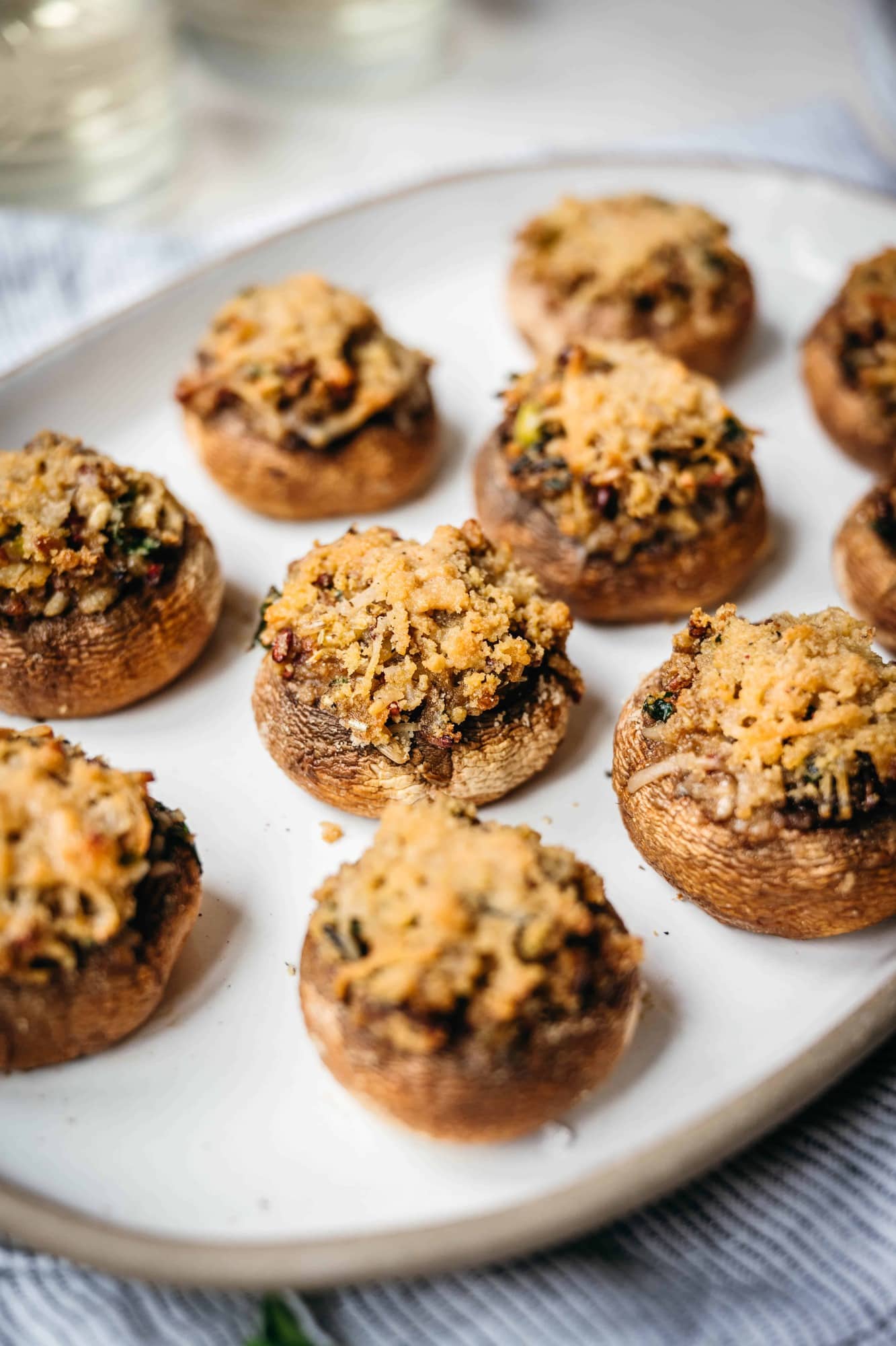 close up side view of vegan stuffed mushrooms on platter