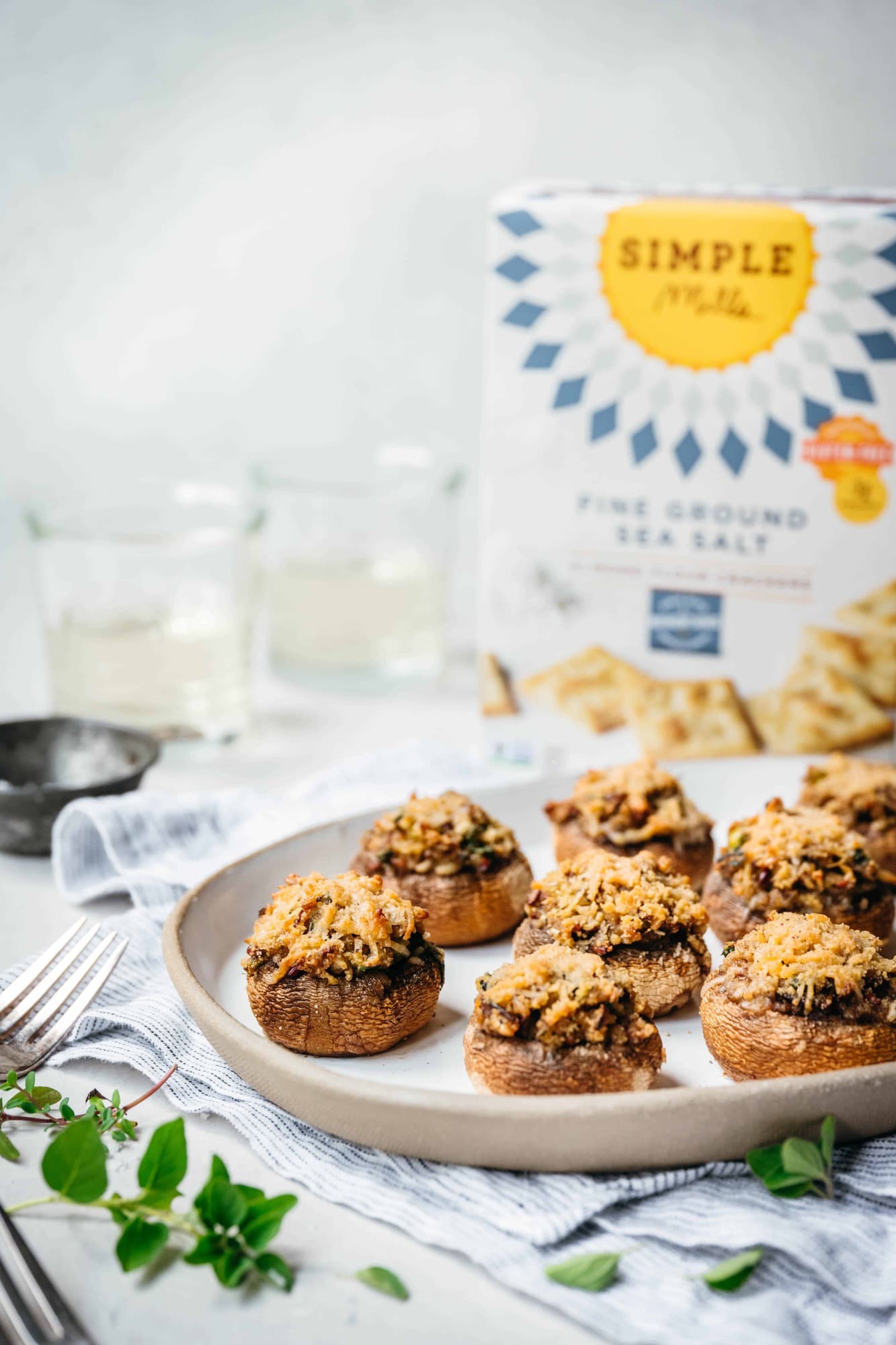 Side view of vegan stuffed mushrooms on a white platter