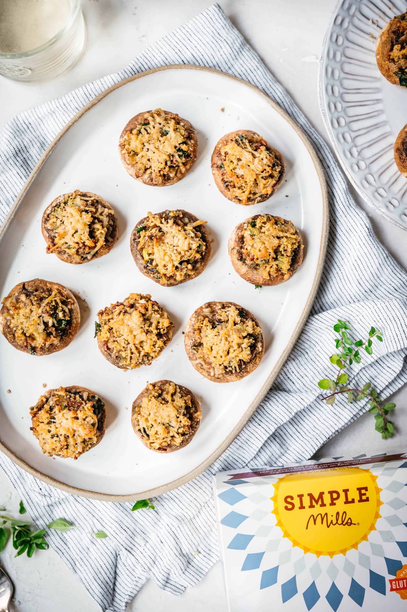 overhead view of vegan and gluten free stuffed mushrooms on white platter