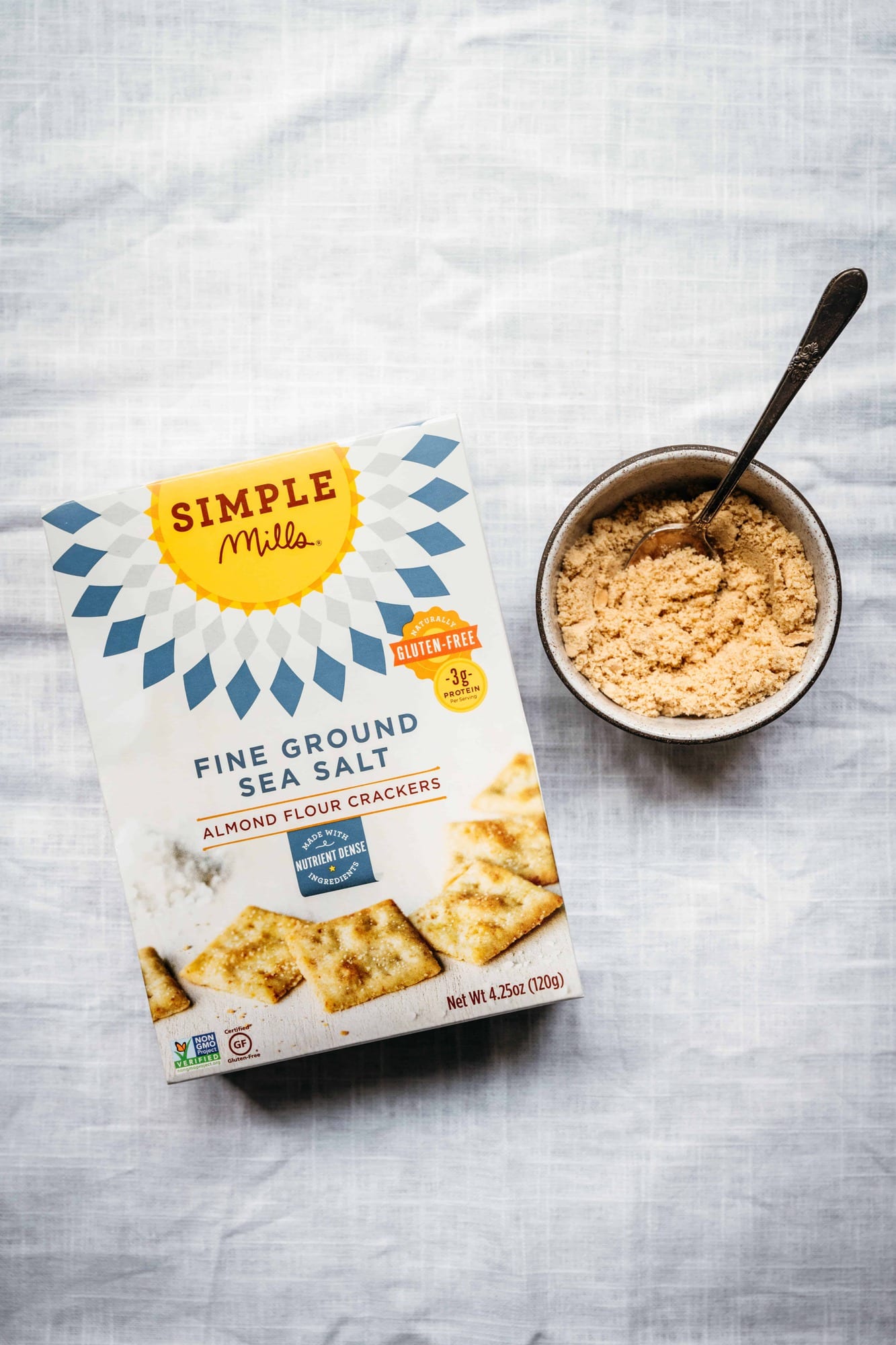 overhead view of simple mills almond flour crackers on white background