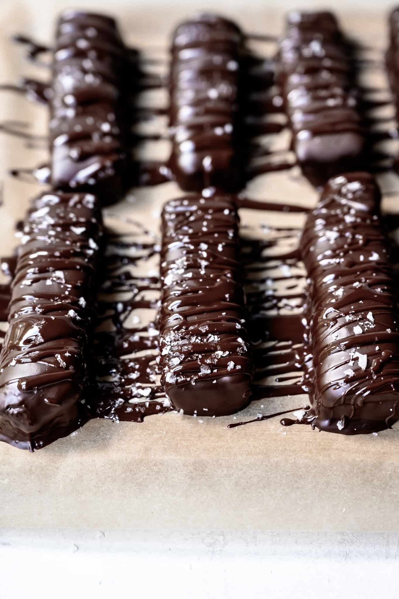 side view of vegan twix bars on parchment paper