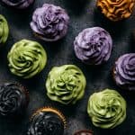 overhead of vegan gluten free cupcakes with frosting colored with natural food coloring