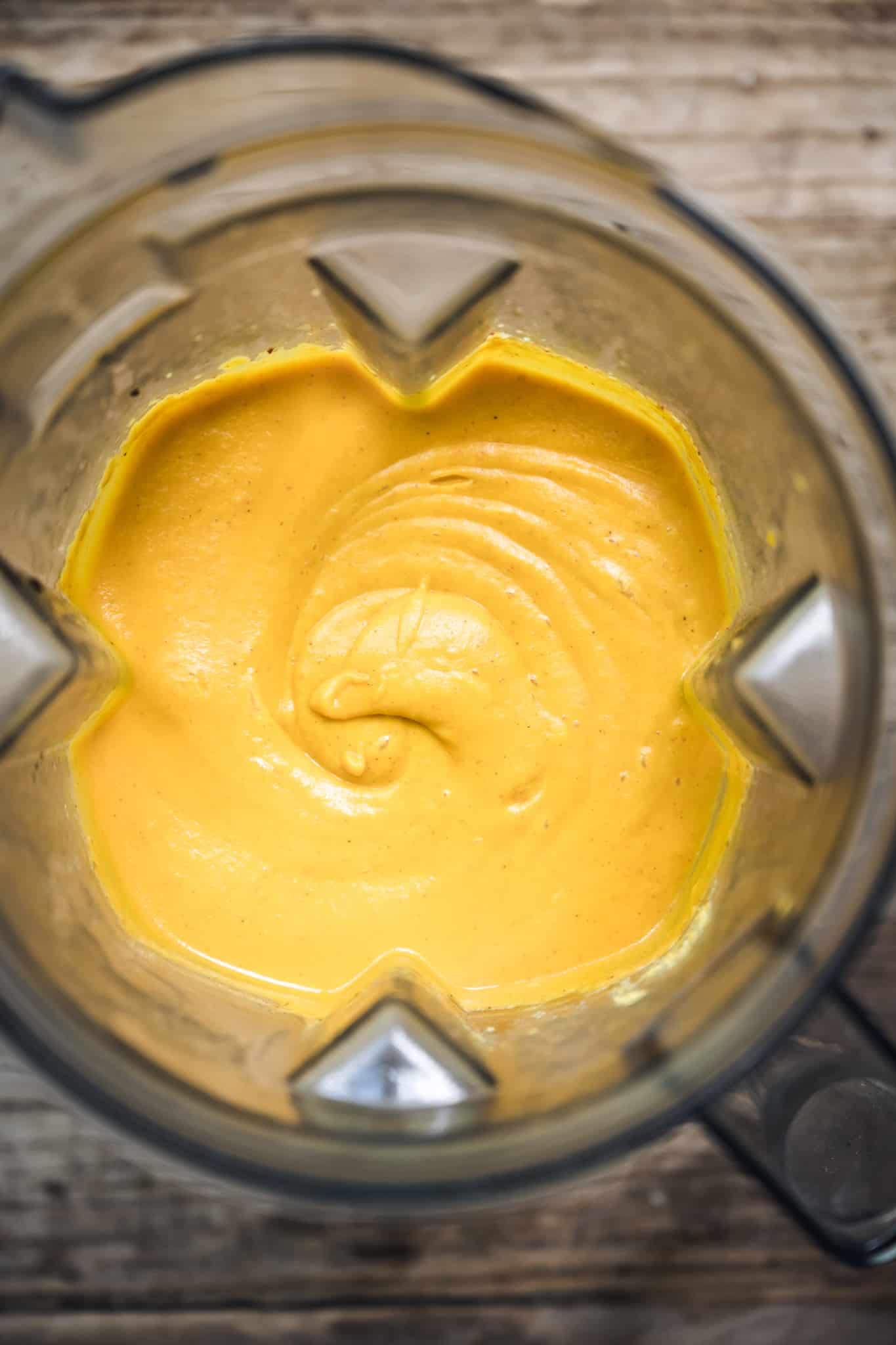 overhead of a blender with just blended vegan nut free cheese sauce