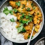 overhead of vegan pumpkin curry with steamed jasmine rice