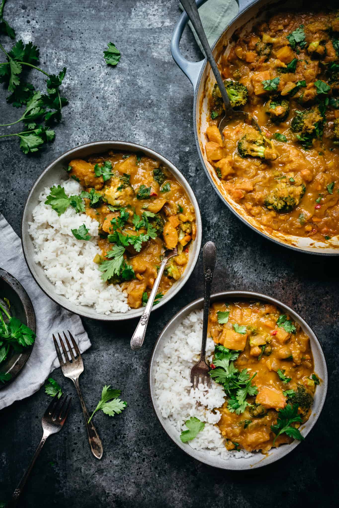 overhead of two bowls of vegan pumpkin curry with jasmine rice